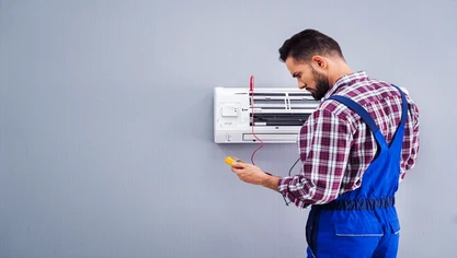 Air conditioner being serviced by a technician